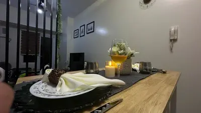 a table with a napkin and a candle on it at Classy BGC Condo City View Pool Gym Sauna in Manila