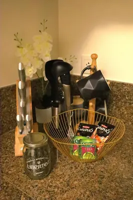 a counter top with a basket of food and a mixer at Classy BGC Condo City View Pool Gym Sauna in Manila