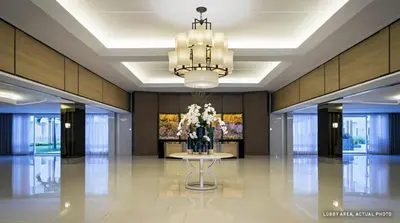 a lobby with a table with a vase of flowers at MOA Staycation - Shell Condo in Manila