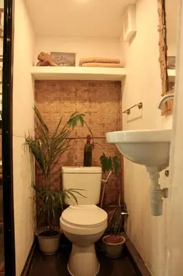 a bathroom with a toilet and a sink at Kamia Tiny Rest House in Sampong