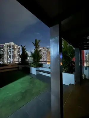 a view from the balcony of a house at night at La Casa Zen - Cozy Studio with private Wi-Fi, complimentary access to Fitness Centre, swimming pool and stunning city view located near the CBD of Ortigas, Makati, BGC in Manila