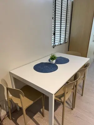 a white table with two blue plates on it at Cozy Spacious BGC Condo near SM Aura, High Street in Manila