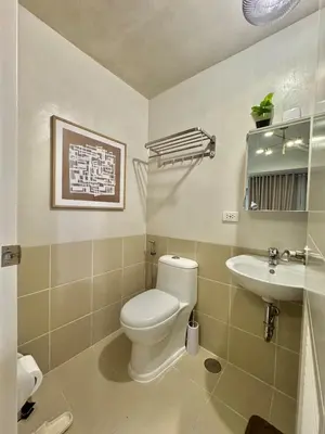 a bathroom with a toilet and a sink at Deluxe Cozy Room Near BGC & Ortigas with Balcony & City View in Manila