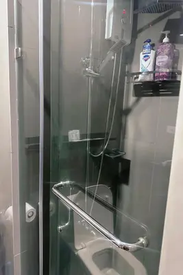 a bathroom with a glass shower with a toilet at Makati Stay Ph in Manila