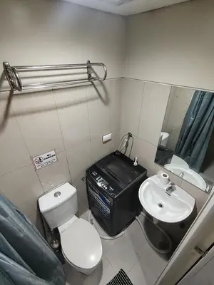 a bathroom with a toilet and a sink at Shell residences Near Moa Japs staycation in Manila