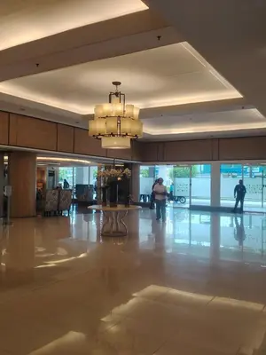 a large lobby with a chandelier in a building at Shell residences Near Moa Japs staycation in Manila