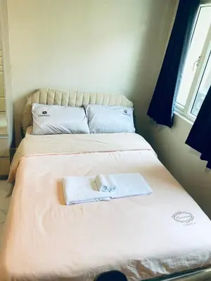 a bedroom with two beds with towels on them at Monarch Parksuites in Manila