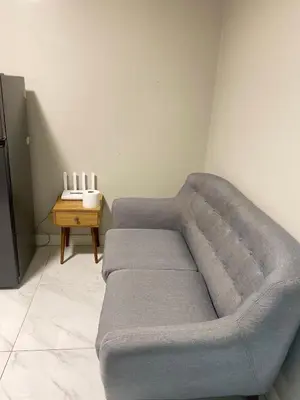 a couch in a living room with a table at Monarch Parksuites in Manila