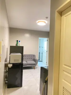 a living room with a couch and a table at Monarch Parksuites in Manila