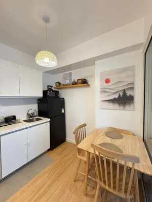 a kitchen and dining room with a table and chairs at Boracay by SIA in Manila