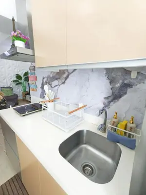 a kitchen with a sink and a white counter top at Boracay by SIA in Manila