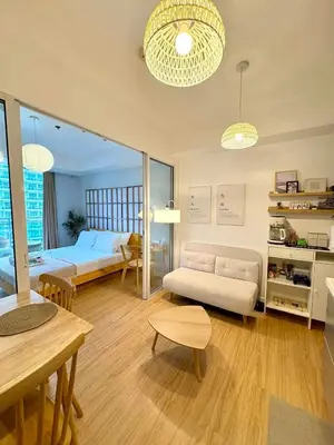 a living room with a bed and a table at Boracay by SIA in Manila