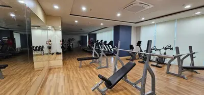 a gym with treadmills and cardio equipment in a building at RM South Staycation in Biñan