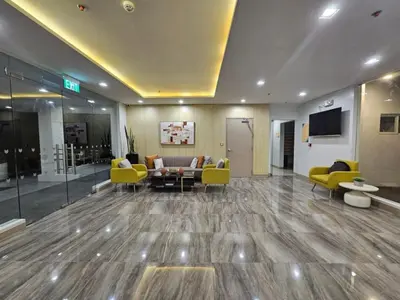 a lobby with yellow chairs and a waiting room at RM South Staycation in Biñan