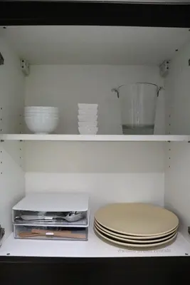 a shelf with plates and bowls in a kitchen at 2BR Condo - Makati CBD, Sunset Views, 20mins to NAIA in Manila