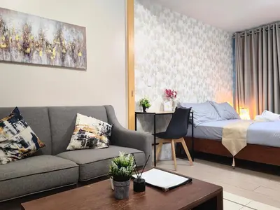 a living room with a couch and a bed at Uptown BGC 1BR Modern Pool View Unit by Terravista in Manila