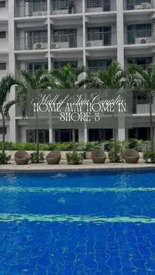 a sign in front of a building with a swimming pool at Luxury Staycation at Shore 3 Mall of Asia in Manila