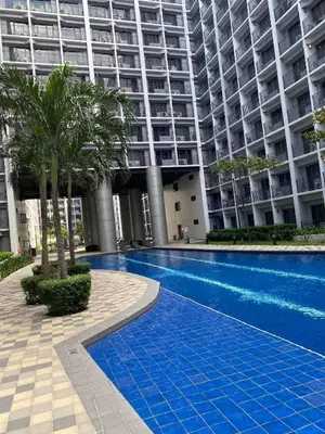 a swimming pool in front of a large building at Luxury Staycation at Shore 3 Mall of Asia in Manila