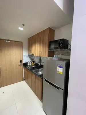 a kitchen with a stainless steel refrigerator and a sink at Luxury Staycation at Shore 3 Mall of Asia in Manila