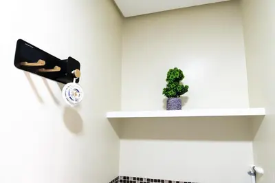 a shelf with a clock and a plant on it at Solemare Parksuites - Condo In Parañaque Near MOA ARENA, SMX CONVENTION CENTER AND DFA MAIN OFFICE in Manila