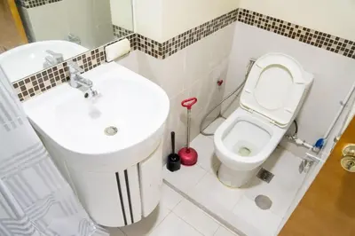 a bathroom with a white toilet and a sink at Solemare Parksuites - Condo In Parañaque Near MOA ARENA, SMX CONVENTION CENTER AND DFA MAIN OFFICE in Manila