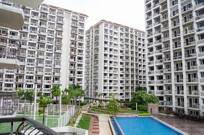a view of two large apartment buildings with a swimming pool at Solemare Parksuites - Condo In Parañaque Near MOA ARENA, SMX CONVENTION CENTER AND DFA MAIN OFFICE in Manila