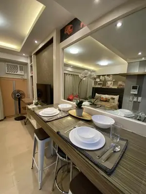 a kitchen with a table with plates on it at Bekipay Suite at Two Palm tree across NAIA 3 in Manila