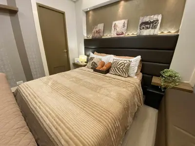 a bedroom with a bed with a teddy bear on it at Bekipay Suite at Two Palm tree across NAIA 3 in Manila