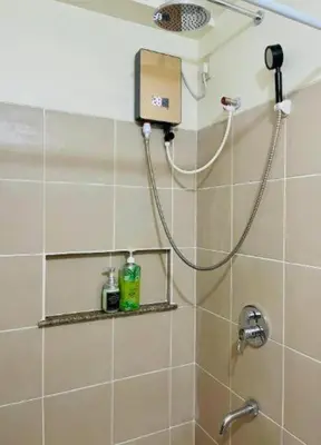 a bathroom with a shower with a shower head at Vtan Condo FAIRLANE PASIG in Manila