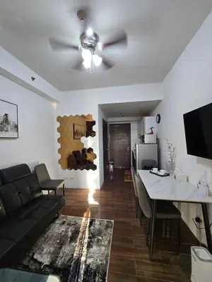 a living room with a couch and a table at Air Residences Makati in Manila