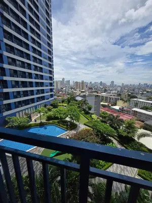 a view of the city from the balcony of a building at Air Residences Makati in Manila