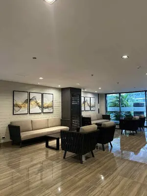 a living room with a couch and tables and chairs at The Air Residences Makati in Manila