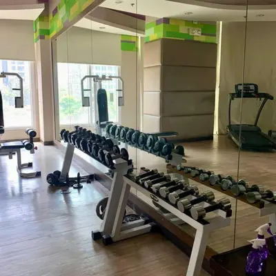 a gym with a bunch of equipment in a room at Vanity Calm Bedroom in Ortigas Center in Manila