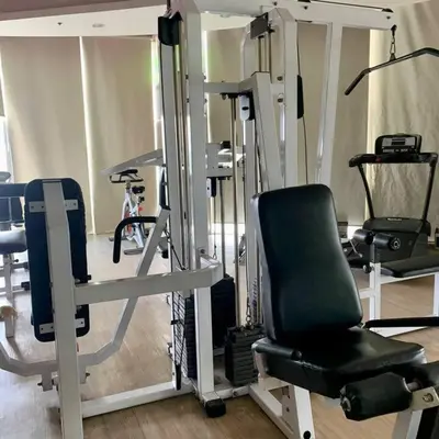 a room with a gym with a chair and machines at Vanity Calm Bedroom in Ortigas Center in Manila