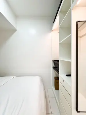 a bedroom with a bed and a closet at Vanity Calm Bedroom in Ortigas Center in Manila