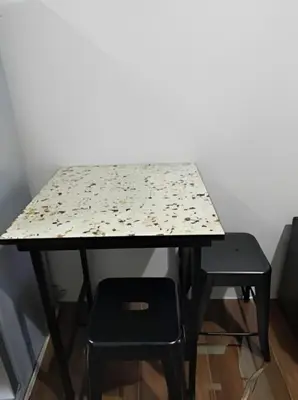 a table with a chair and a table with at Makati Staycation at Air Residences in Manila