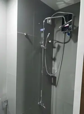 a shower in a bathroom with a glass wall at Makati Staycation at Air Residences in Manila