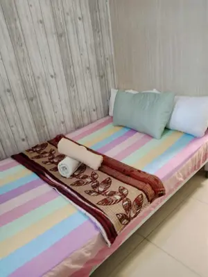 a bed with a colorful blanket and pillows on it at Sea residences Christine prime in Manila