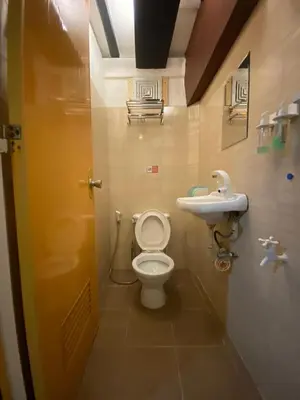 a bathroom with a toilet and a sink at Adorable - 2A, Chill Room in Manila