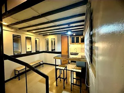 a kitchen with a table and chairs in a room at Adorable - 2A, Chill Room in Manila