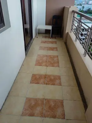 a hallway with a tiled floor in a building at Apartment in Rhapsody 2BR in Manila