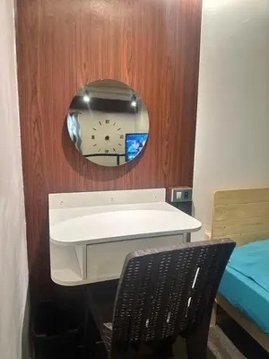 a mirror and a desk and a chair in a room at Adorable - 2B, Stunning Lounge in Manila