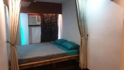a small bed in a room with a window at Adorable - 2C, Love Nest Studio unit in Manila