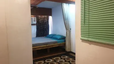 a small room with a bed in a window at Adorable - 2C, Love Nest Studio unit in Manila