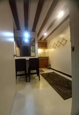 a room with two chairs and a table with a mirror at Adorable - 2C, Love Nest Studio unit in Manila