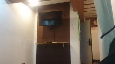 a room with a door with a flat screen tv on the wall at Adorable - 2C, Love Nest Studio unit in Manila