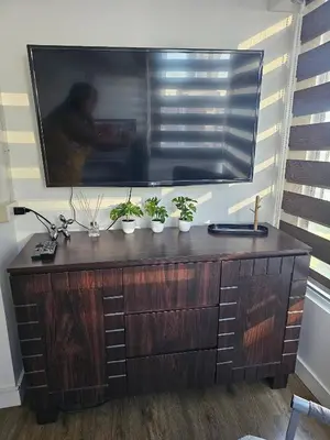 a large tv on a wall with potted plants on it at Casa Rosa3 2BR loft in BGC 5 people in Manila