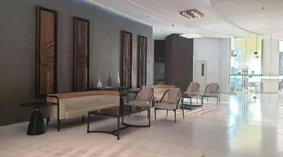 a waiting room with chairs and tables in a building at Casa Rosa3 2BR loft in BGC 5 people in Manila