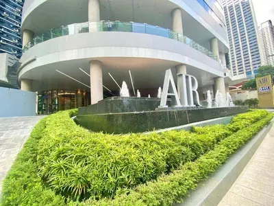 a building with a fountain in front of it at SOLACE by Athena at Air Residences Makati in Manila