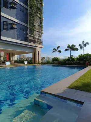 a large swimming pool in front of a building at Red Residences in Manila